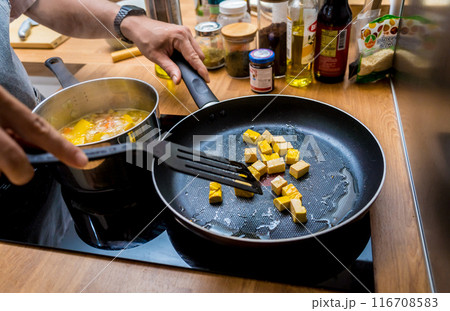 Chef at the kitchen preparing pumpkin porridge with tofu and vegetables 116708583