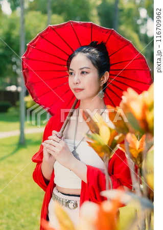 Northern Thai Chiangmai lanna people in traditional style clothes beautiful women old vintage dressing with paper umbrella at wat ton kwen. 116709962