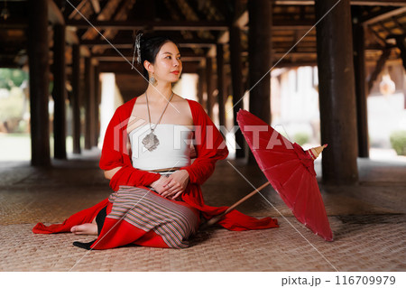 Northern Thai Chiangmai lanna people in traditional style clothes beautiful women old vintage dressing with paper umbrella at wat ton kwen. 116709979