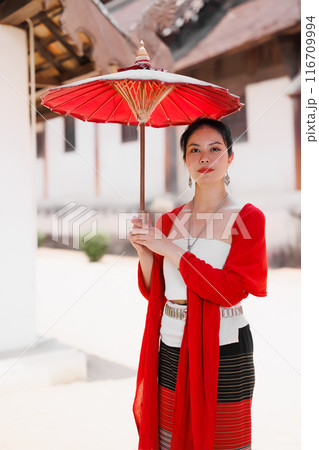 Northern Thai Chiangmai lanna people in traditional style clothes beautiful women old vintage dressing with paper umbrella at wat ton kwen. Northern Thai Chiangmai lanna people in traditional style clothes beautiful women old vintage dressing with paper umbrella at wat ton kwen. 116709994