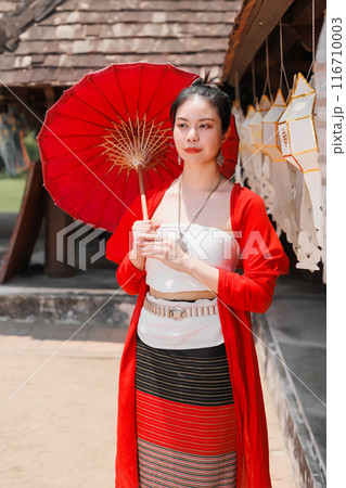 Northern Thai Chiangmai lanna people in traditional style clothes beautiful women old vintage dressing with paper umbrella at wat ton kwen. 116710003