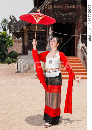 Northern Thai Chiangmai lanna people in traditional style clothes beautiful women old vintage dressing with paper umbrella at wat ton kwen. 116710007