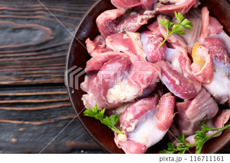 Raw chicken giblets gizzard ( stomach ) , meat background Raw chicken giblets gizzard ( stomach ) , meat background 116711161