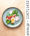 Asparagus and poached eggs with jamon and fresh dill 116711432