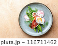 Asparagus and poached eggs with jamon and radishes 116711462