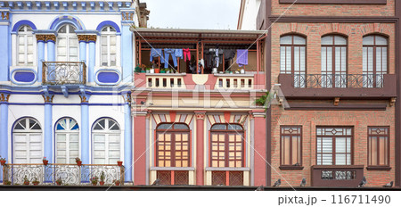 Street view with facades of old colonial buildings in Quito, Ecuador. 116711490
