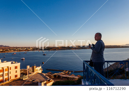 Young man taking a photos of the Red Sea in Sharm El Sheikh, Egypt 116712290