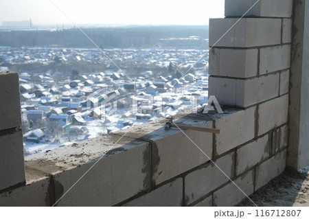 Build create wall of multi-storey building of blocks under construction in city. Build create wall of multi-storey building of blocks under construction in city. 116712807