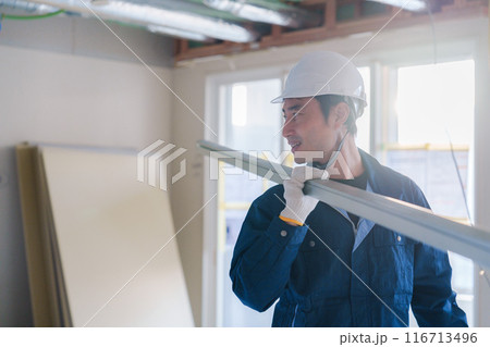 建設現場で資材を運ぶ男性の職人 建設現場で資材を運ぶ男性の職人 116713496