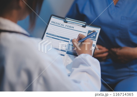 Charming female doctor giving advice to a female patient. 116714365