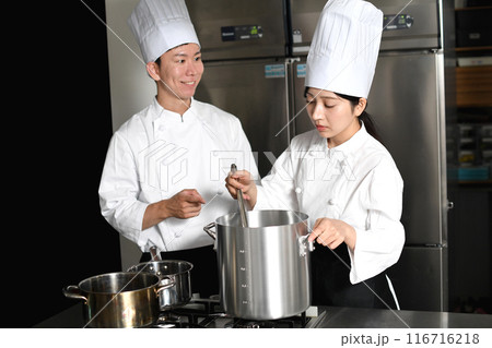 厨房で調理する若いアジア人の男女の調理師 116716218