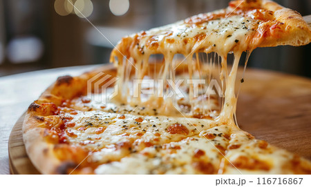 Cheesy pizza slice being served. 116716867