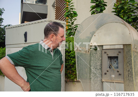 From Necessity to Neglect: Man Gazes at Disused Payphone, Contemplates Technological Progress. 116717635