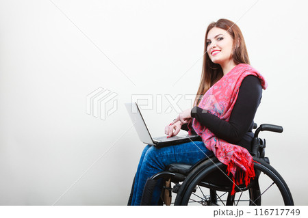 Young girl on wheelchair surfing web. Young girl on wheelchair surfing web. 116717749