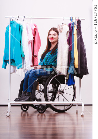 handicapped girl on wheelchair choosing clothes handicapped girl on wheelchair choosing clothes 116717761