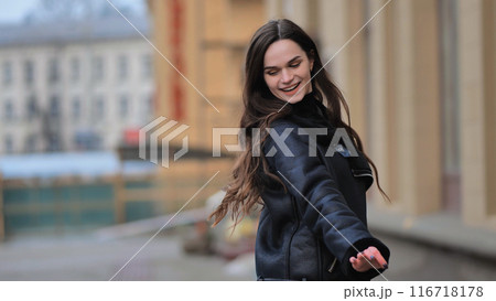 urban portrait of a stylish brunette girl in a black jacket urban portrait of a stylish brunette girl in a black jacket 116718178