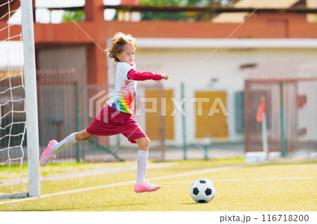 Child playing football. Kids play soccer. 116718200