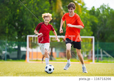 Child playing football. Kids play soccer. 116718266
