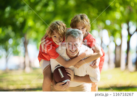 Family playing American football. Kids play rugby Family playing American football. Kids play rugby 116718267