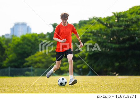 Young man playing football. Young man playing football. 116718271