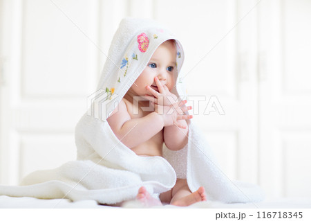 Little baby on white bed 116718345