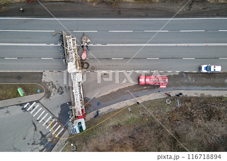 Aerial view of road accident with overturned truck blocking traffic 116718894