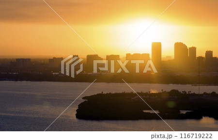Aerial view of downtown district of Tampa city in Florida, USA at sunset. Dark silhouette of high skyscraper office buildings in modern american midtown Aerial view of downtown district of Tampa city in Florida, USA at sunset. Dark silhouette of high skyscraper office buildings in modern american midtown 116719222