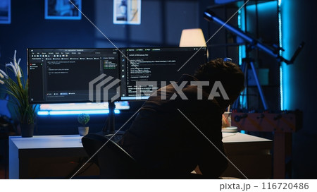 Software developer putting face in hands in frustration while updating binary code script on computer, receiving errors. Admin in apartment exasperated by annoying bugs while programming, camera A Software developer putting face in hands in frustration while updating binary code script on computer, receiving errors. Admin in apartment exasperated by annoying bugs while programming, camera A 116720486