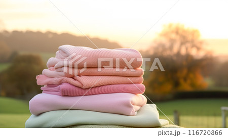 Laundry, housekeeping and homemaking, stack of clean and folded clothes in the countryside, post-processed, generative ai 116720866