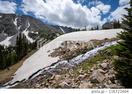 Melting glacier on Lake Isabelle Trail, Colorado under sunny summer cloudscape. 116721604