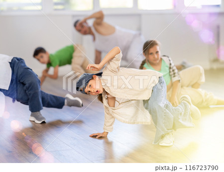 Preteen girl performing hip hop in group class for kids Preteen girl performing hip hop in group class for kids 116723790