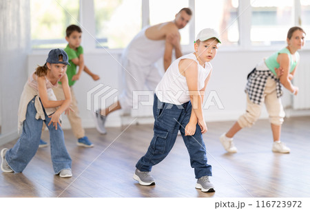 Tween boy dancer rehearsing krump dance in kids studio Tween boy dancer rehearsing krump dance in kids studio 116723972