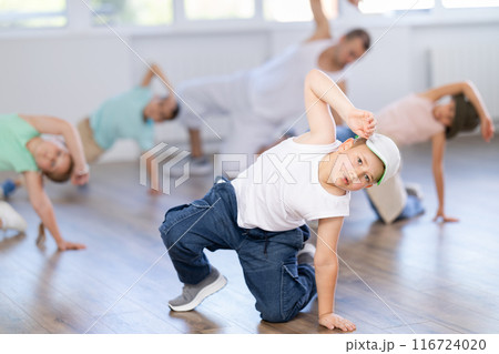 Preteen boys and girls studying movement of contemporary dance in classroom with his friends 116724020