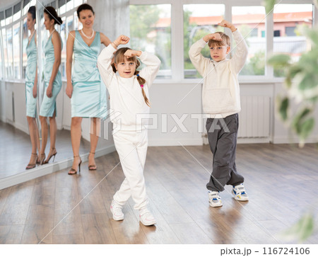 Boy and girl train to dance contemporary vigorous boogie woogie during classes. Boy and girl train to dance contemporary vigorous boogie woogie during classes. 116724106