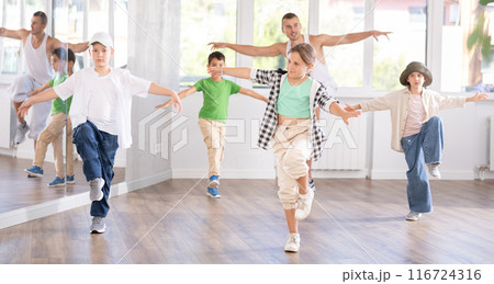 Girls and boys performing hip hop dance training hall during group dancing classes 116724316