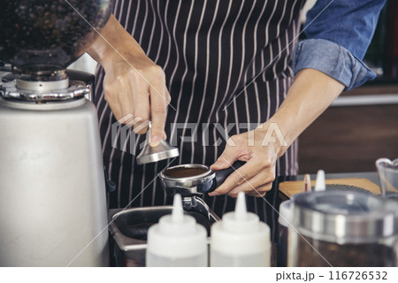 Close up hands coffee barista man make hot cup espresso shot from coffee machine. Cappuccino with milk in italian coffee shop cafe. Close up hands of barista use machine make black drinking hot cup Close up hands coffee barista man make hot cup espresso shot from coffee machine. Cappuccino with milk in italian coffee shop cafe. Close up hands of barista use machine make black drinking hot cup 116726532