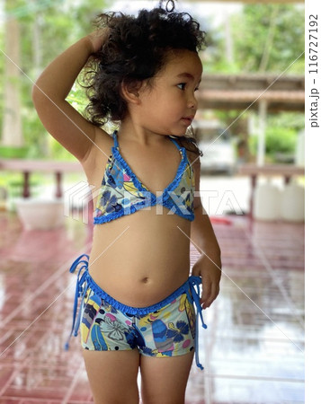 Portrait of a cute smiling little Asian girl in blue swimsuit Portrait of a cute smiling little Asian girl in blue swimsuit 116727192