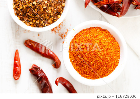 Dried red chilies on white wooden table. 116728030