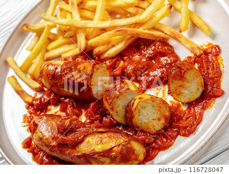 pork sausages in a curry sauce with french fries pork sausages in a curry sauce with french fries 116728047