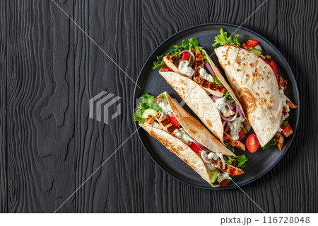 grilled chicken street tacos on a dark plate grilled chicken street tacos on a dark plate 116728048