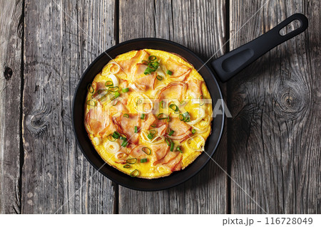 deli ham onion omelette on skillet, top view deli ham onion omelette on skillet, top view 116728049