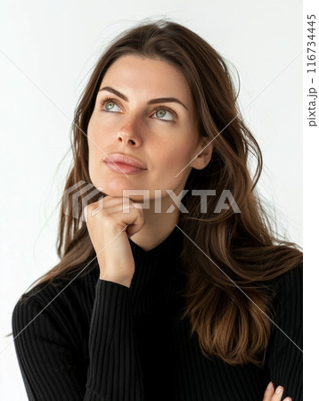 An intimate portrait of a brunette woman with piercing green eyes, her thoughtful expression inviting contemplation. Her subtle hand gesture adds to her enigmatic allure. 116734445