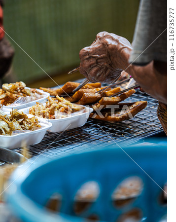 Street Food Vendor Serving Deep Fried Snacks Street Food Vendor Serving Deep Fried Snacks 116735777