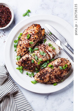 Fried sumak chicken with green onion on white plate. Fried sumak chicken with green onion on white plate. 116736135