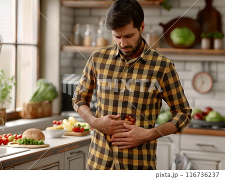 Man Regretting Food Choices in Kitchen Feels Stomach Discomfort and Concern Over Unhealthy Meal Man Regretting Food Choices in Kitchen Feels Stomach Discomfort and Concern Over Unhealthy Meal 116736237