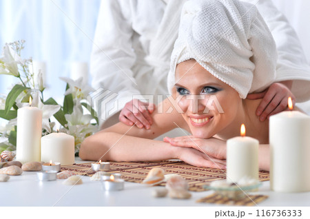 Beautiful woman in spa centar enjoying the massage. 116736333