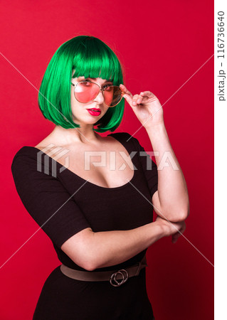 Confident Woman with Green Hair and Pink Sunglasses Confident Woman with Green Hair and Pink Sunglasses 116736640