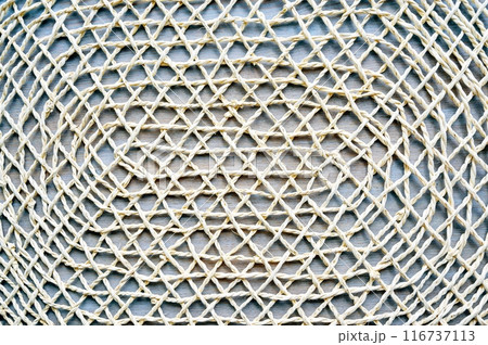Close-up of lace tablecloth background. Decorative handmade knitted cloth.Textured wooden textile table cover. 116737113