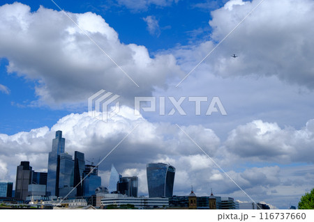 City of London business district Shiny Skyscrapers set against a dramatic stormy sky. 116737660