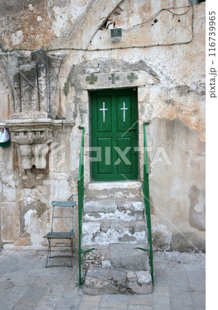 Church of the Holy Sepulcher roof detail steps to green door with wooden banisters handrail and Cross, Jerusalem, Israel  116739965